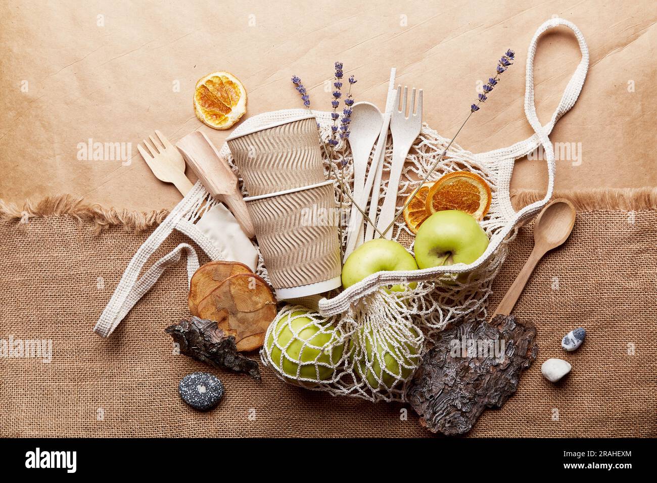 Aesthetic, natural, eco-friendly concept. Eco shopping bag with wooden and paper cutlery, apples, bark tree, lavender. Sustainable, zero waste, plasti Stock Photo