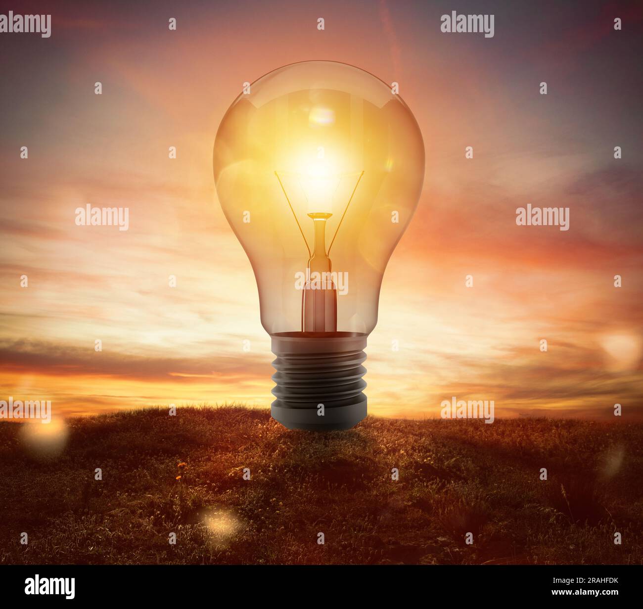 Big lightbulb in a field during the sunset ads concept of idea Stock ...