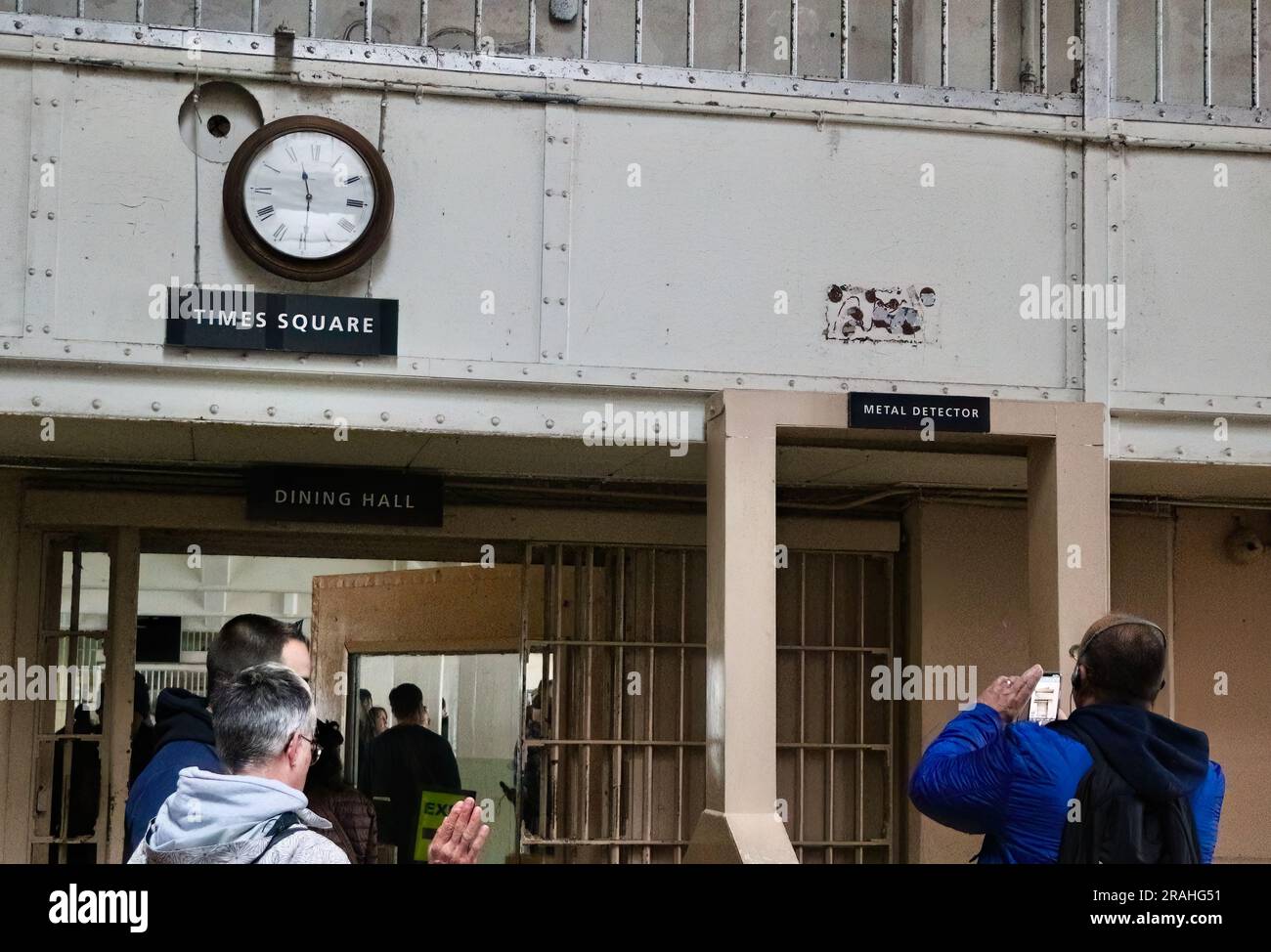 Clock over the Times Square sign next to a metal detector at the