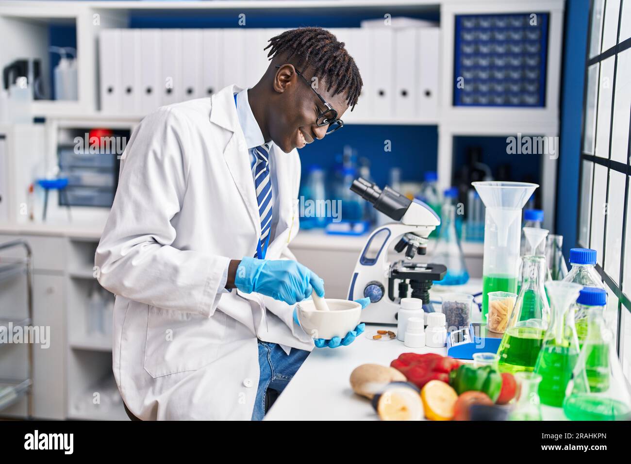African american man scientist smiling confident mixing sample at ...