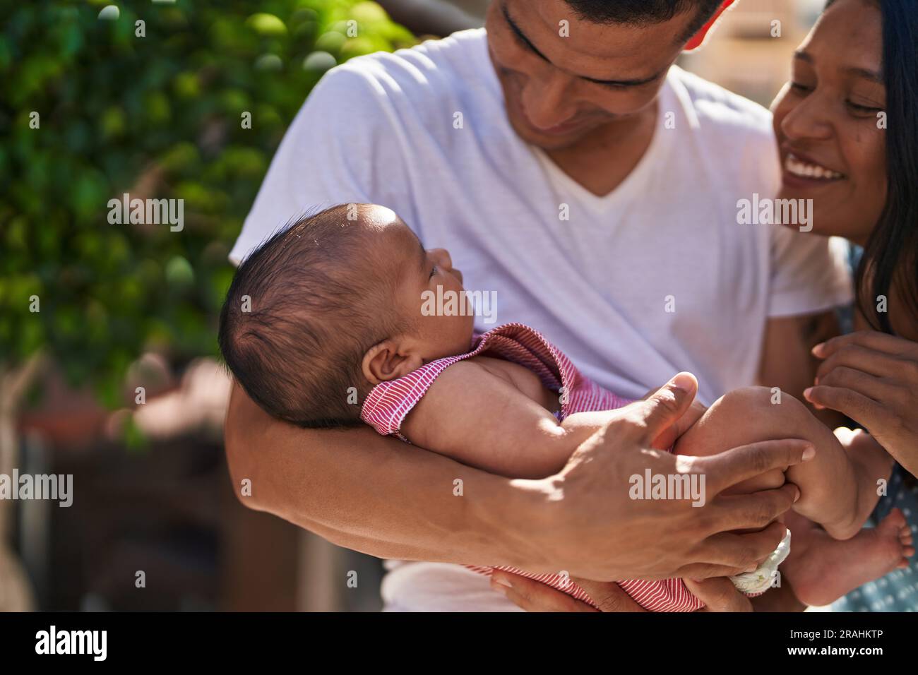 Hispanic family smiling confident hugging each other at street Stock Photo