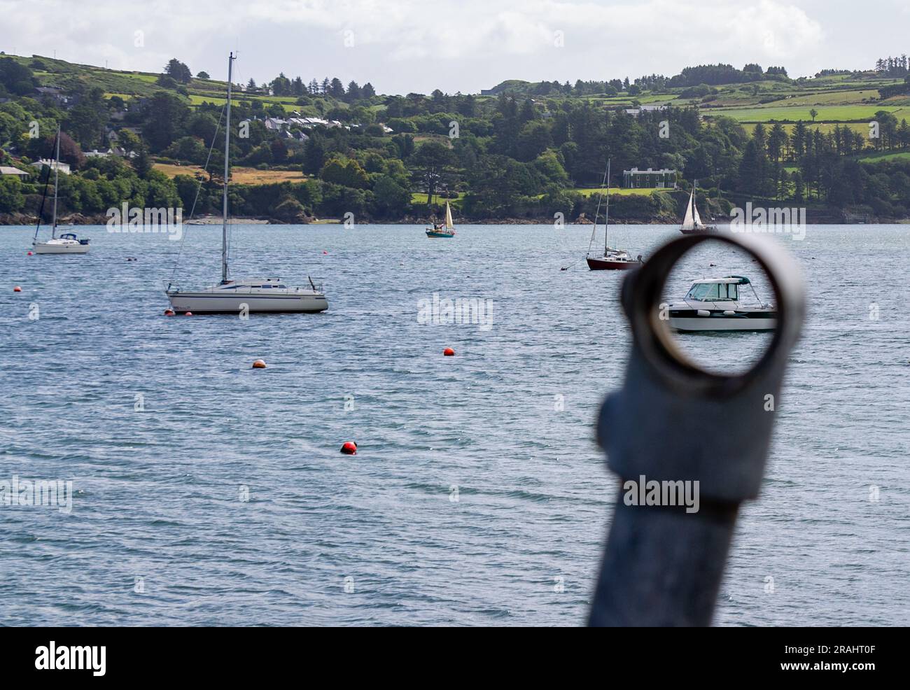 Boats in Harbour or Harbor with boat seen through hole in Guard Rail