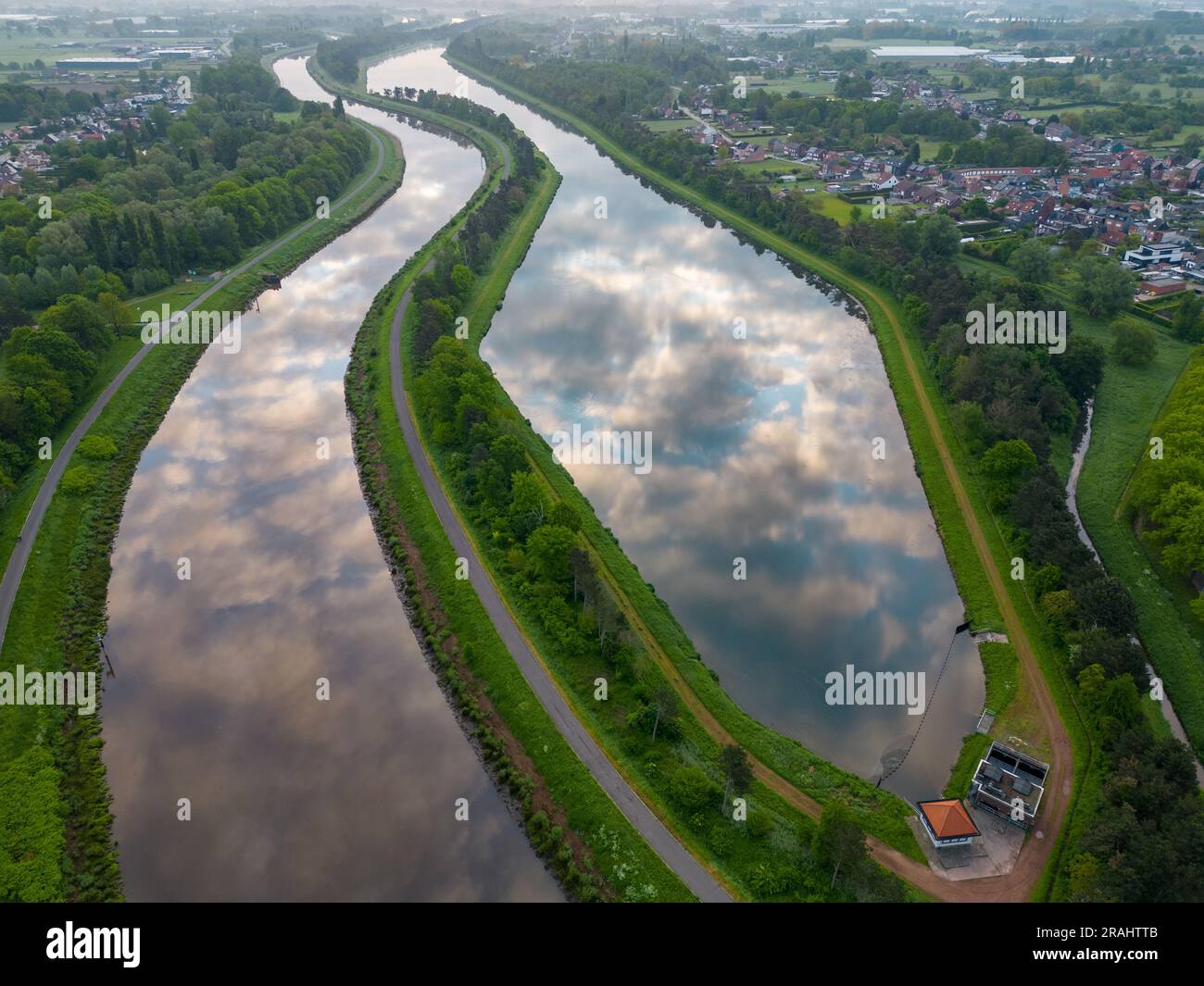 Aerial view of a colorful dramatic sunrise sky over the river Nete in Duffel, Belgium. River with water for transport, agriculture. Fields and meadows. River and forest landscape. High quality photo Stock Photo