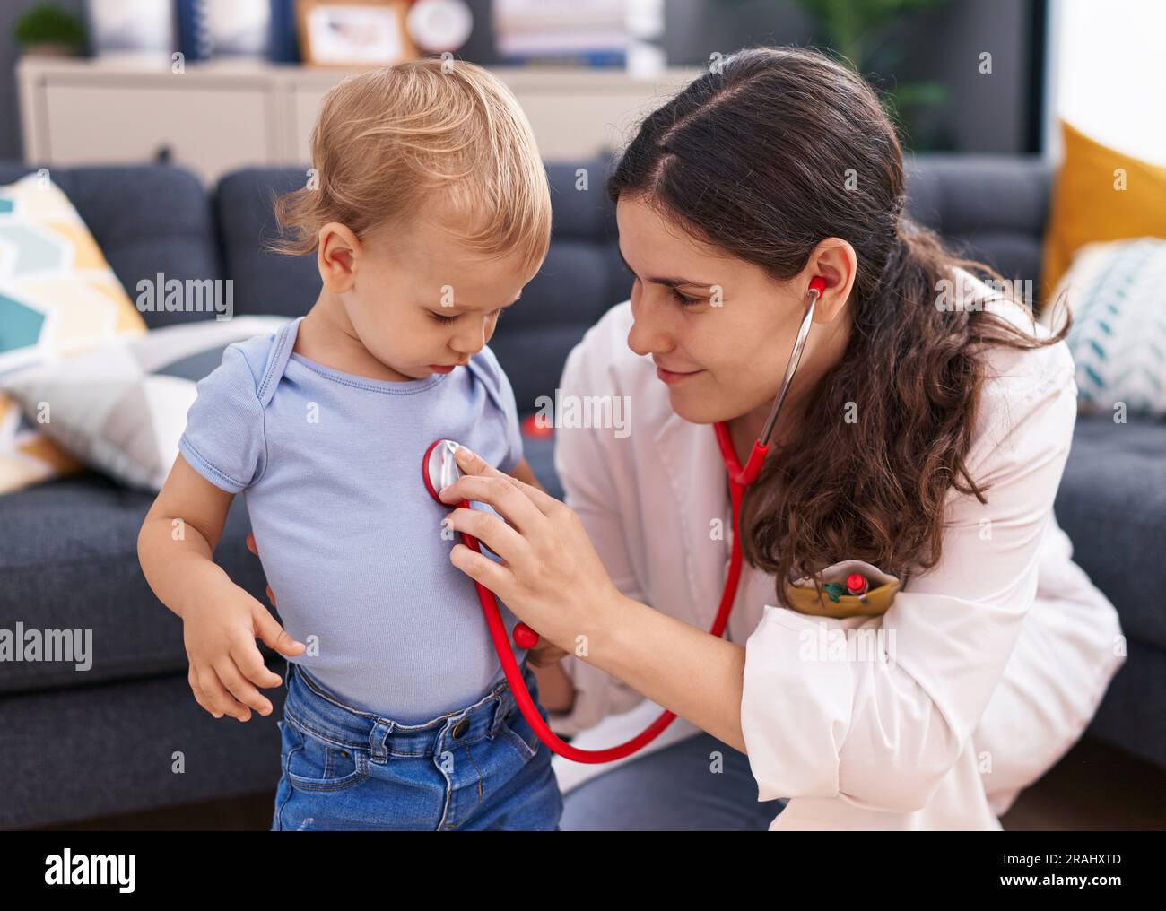 Mother and son doctor examining child at home Stock Photo - Alamy