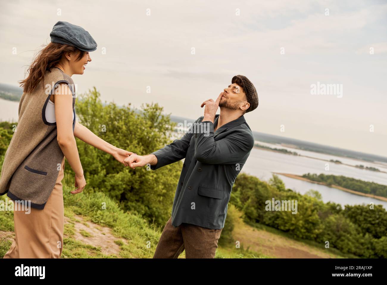 Fashionable man in newsboy cap and jacket showing secret gesture and ...