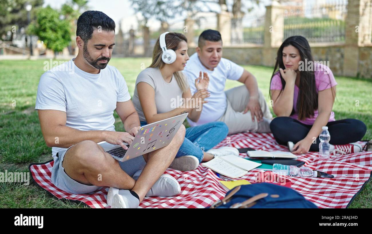 Group of people students sitting on grass studying at park Stock Photo ...