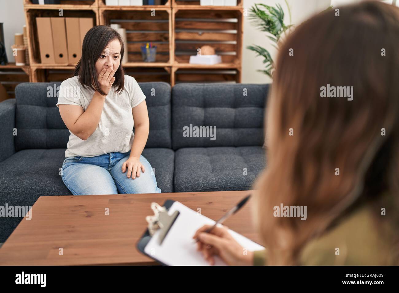 Hispanic girl with down syndrome doing therapy bored yawning tired