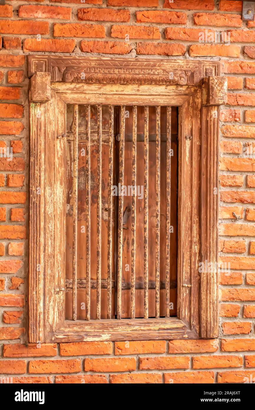 Antique wooden window with wrought iron and brick wall Stock Photo - Alamy