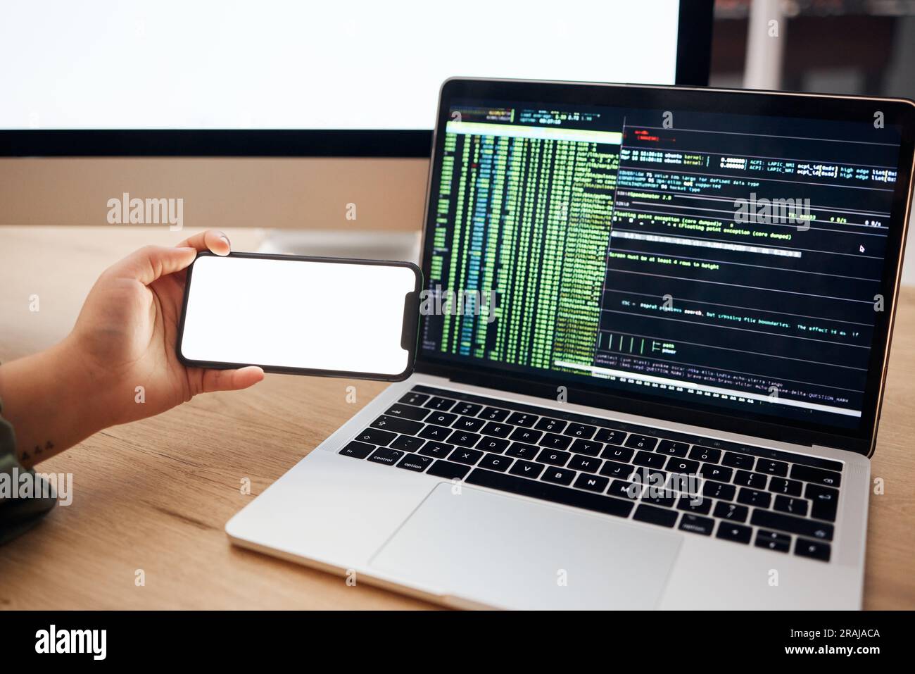 Laptop, coding and hands with mockup phone for website hacking, programming or cybersecurity. Information technology, software and person on Stock Photo