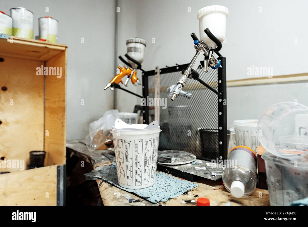 Airbrush paint gun in paint in car service station Stock Photo Alamy