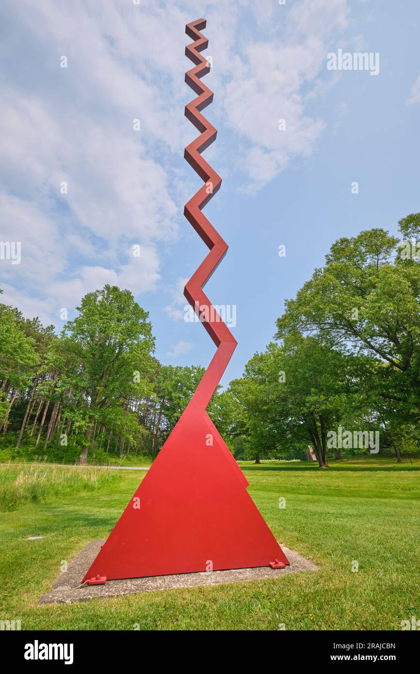 A view of the tall, red, squiggly line sculpture titled Endless Column