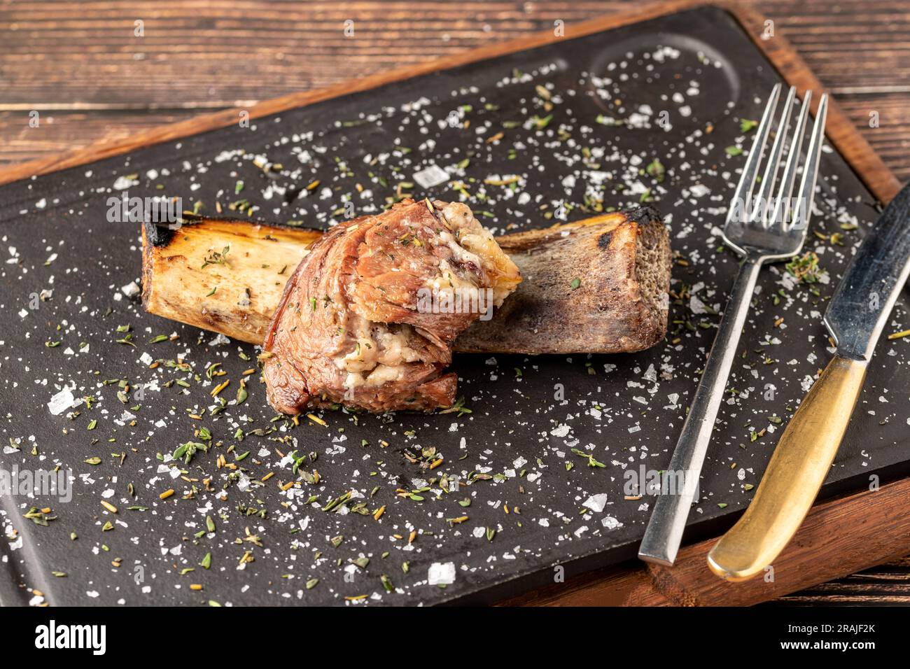 Beef rib asado on stone cutting board at steakhouse Stock Photo