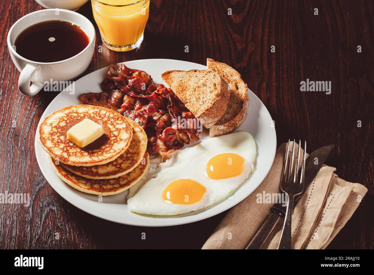 traditional full american breakfast eggs pancakes with bacon and toast Stock Photo