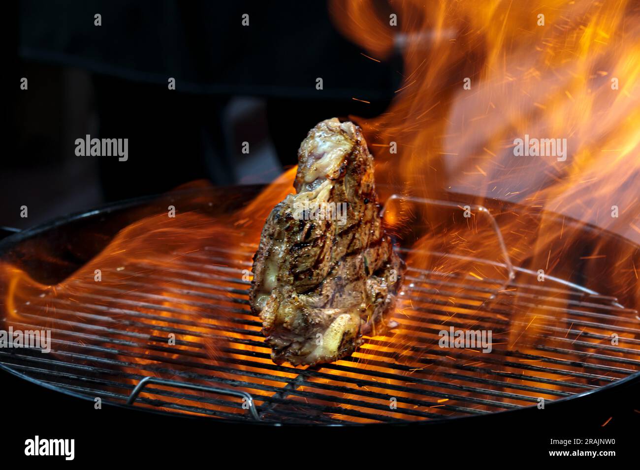 Grill steak tomahawk. Angus beef tbone on fire flame. Wood charcoal bbq