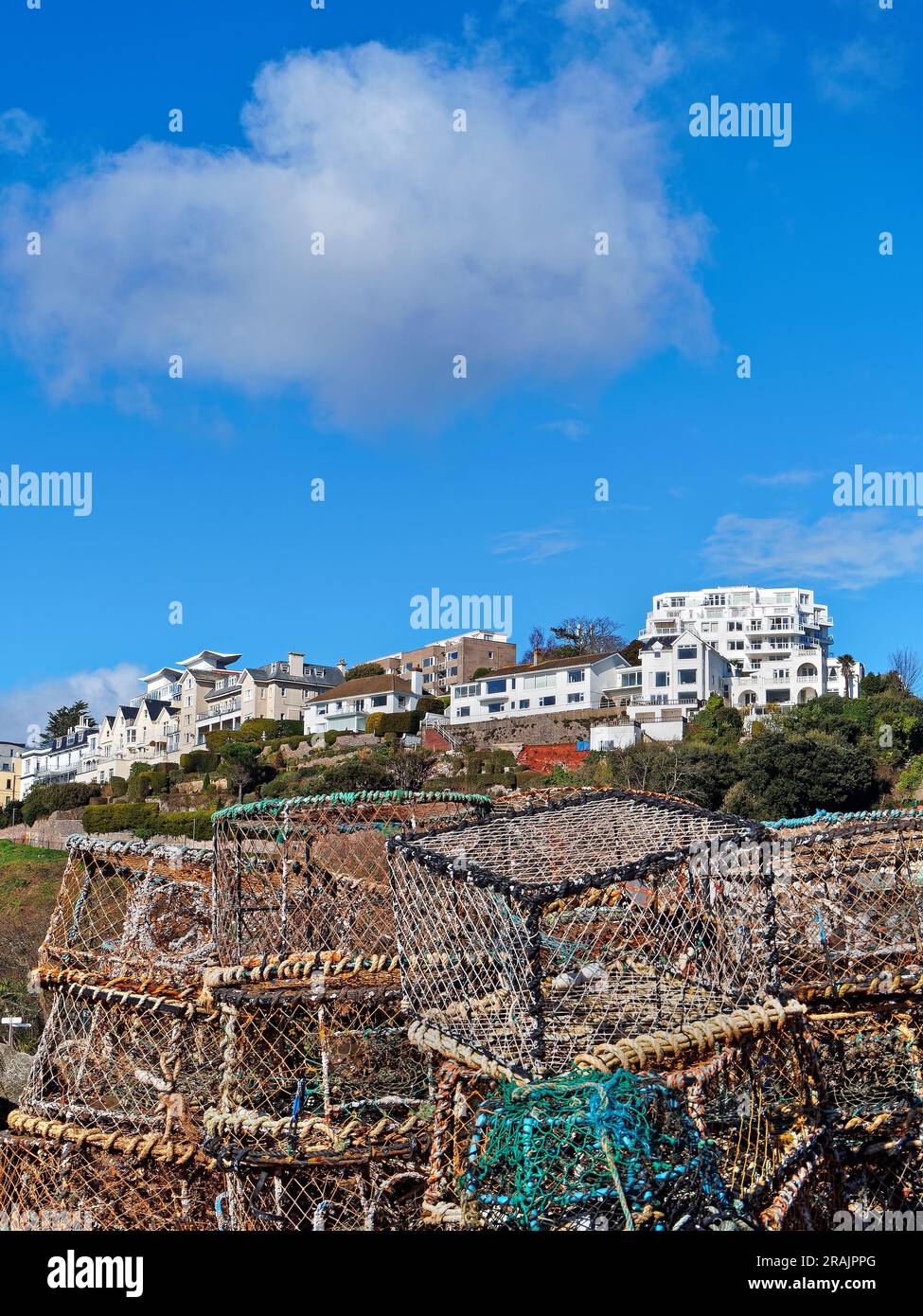 UK, Devon, Torquay Harbour Lobster Pots overlooked by Hotels and