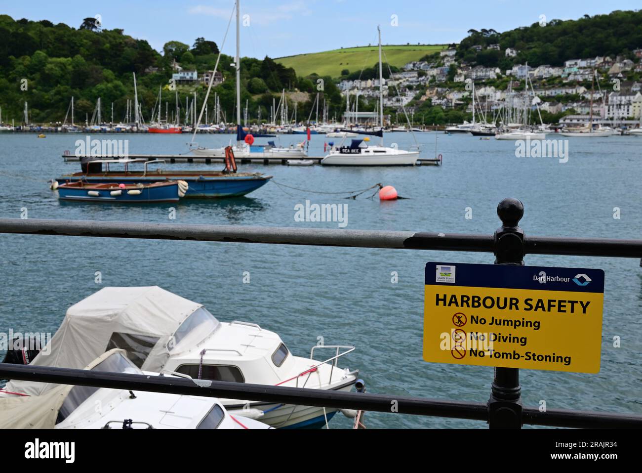 Harbour Safety notice on railings beside the river Dart in Dartmouth, South Devon Stock Photo