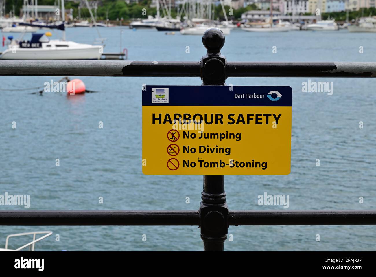 Harbour Safety notice on railings beside the river Dart in Dartmouth, South Devon Stock Photo