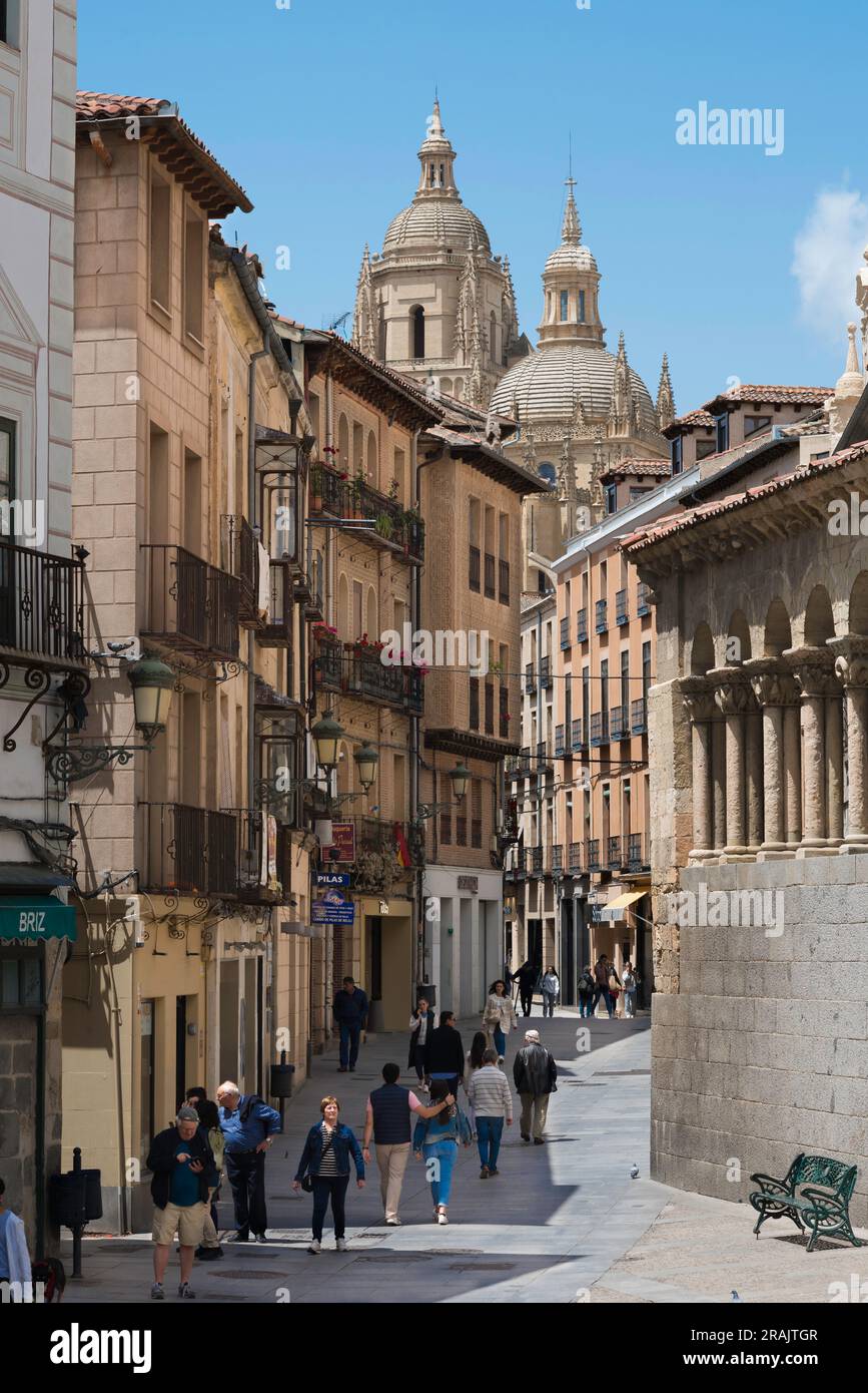 Segovia historic, view of the Calle Juan Bravo - the main thoroughfare of Segovia Old Town - showing the Romanesque wall of Iglesia San Martin (right) Stock Photo