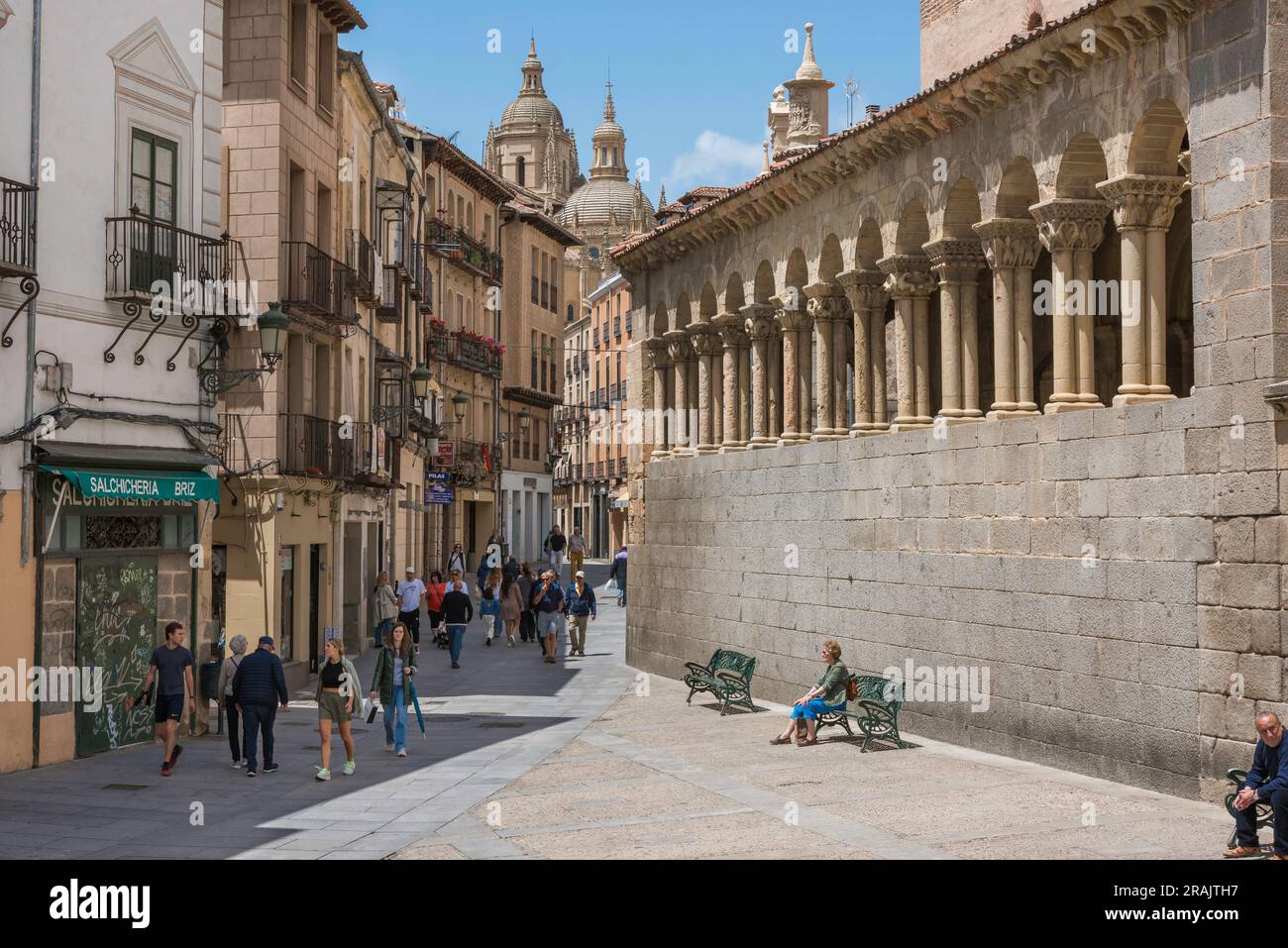 Segovia Old Town, view of the Calle Juan Bravo - the main thoroughfare of Segovia Old Town - showing the Romanesque wall of Iglesia San Martin (right) Stock Photo