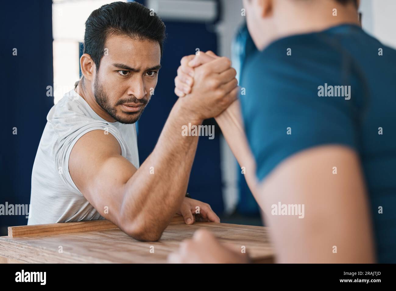 Strength, motivation and male people arm wrestling on a table while