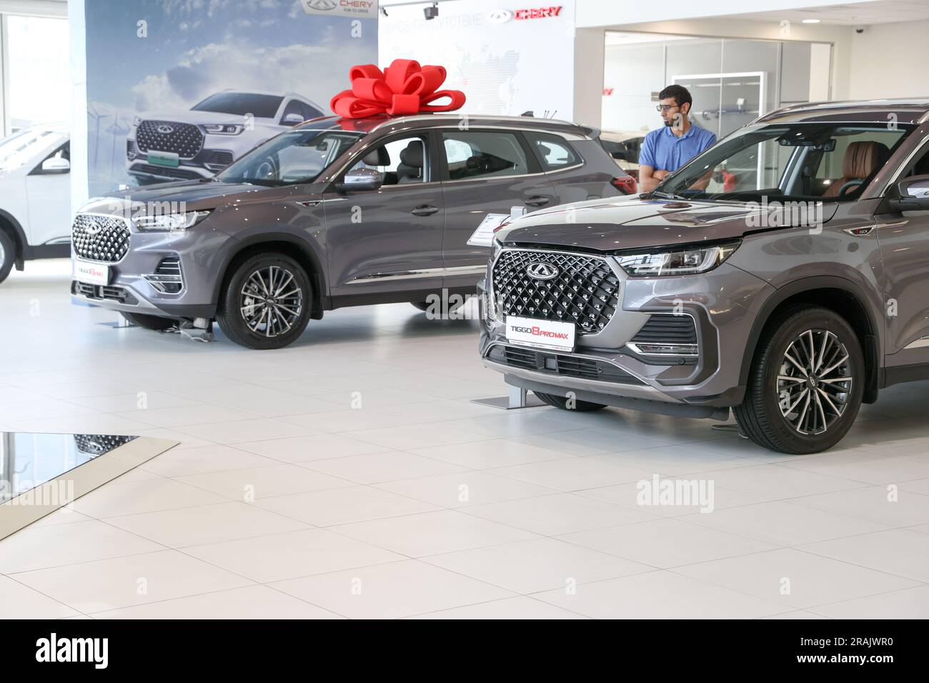 Russia. Moscow. A buyer near a Chery car at the Avilon car dealership ...