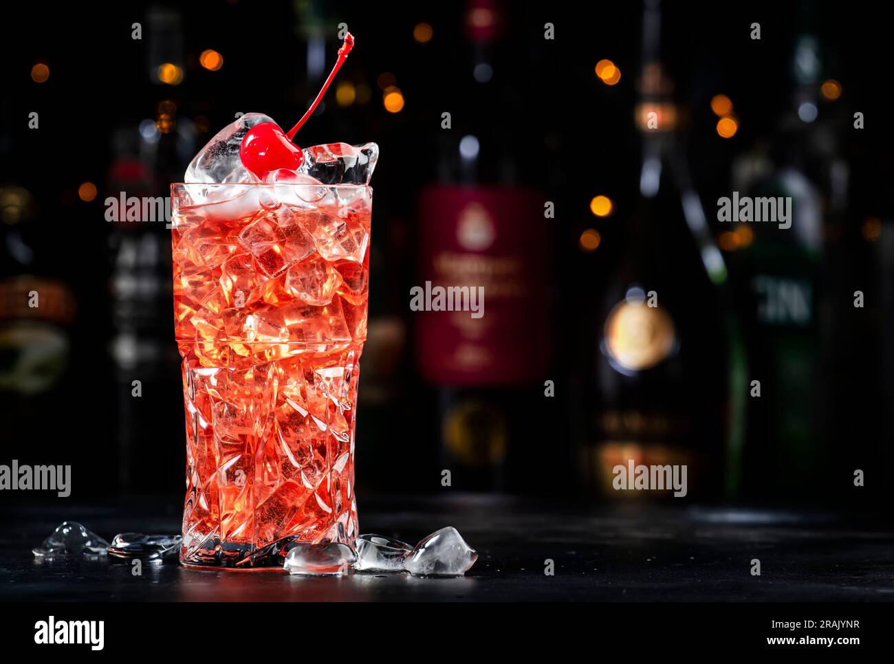 Rose with cherry, alcoholic cocktail drink with pink vermouth, amaretto liqueur, cherry juice
