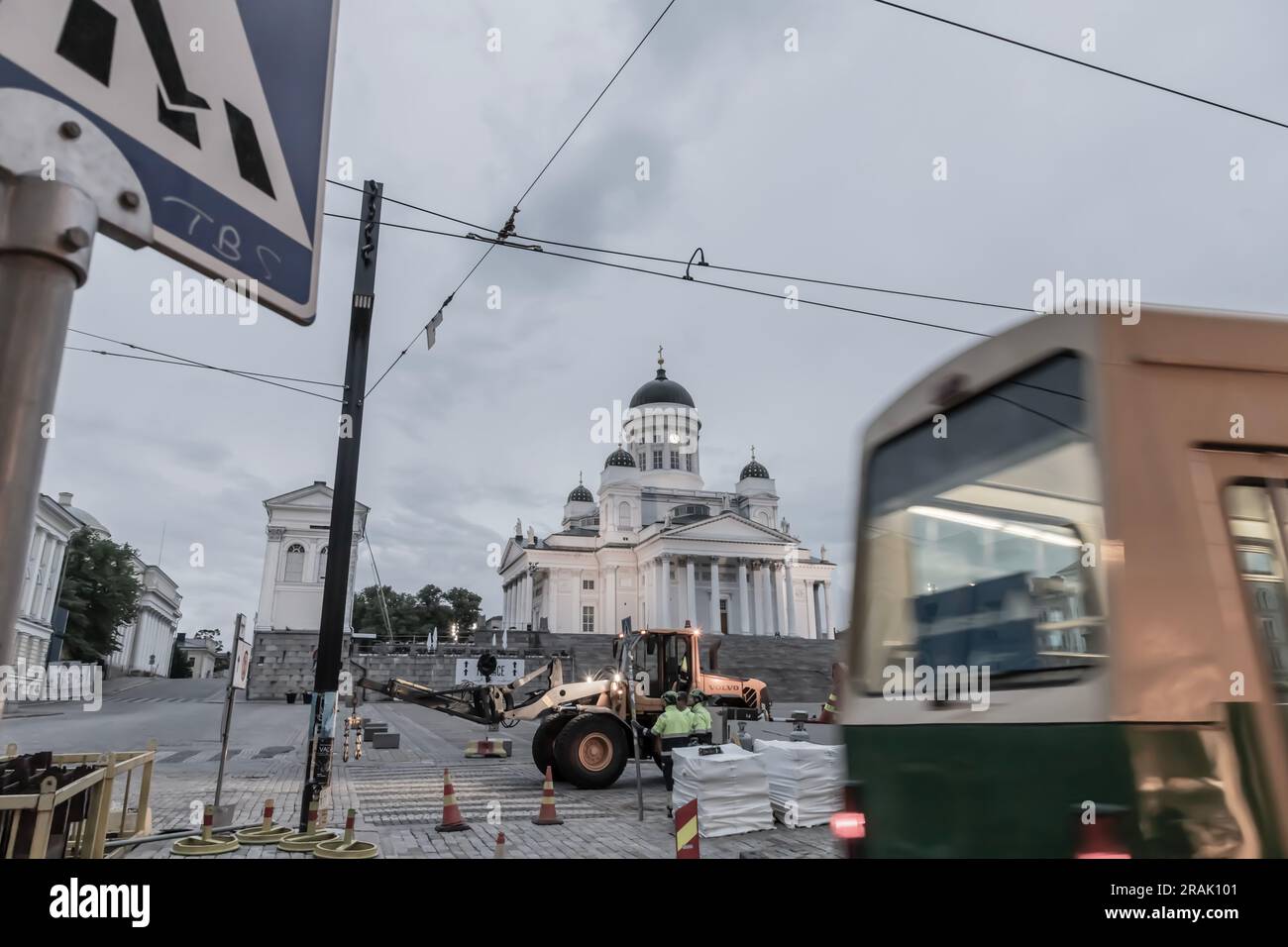 Wide-angle photo of construction work in the Senate Square at night. In the background, the Helsinki Cathedral. A tram in the foreground. Stock Photo