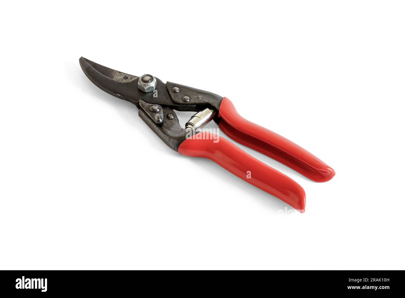 A pair of red-handled garden secateurs in closed position, isolated on a white background,, UK Stock Photo
