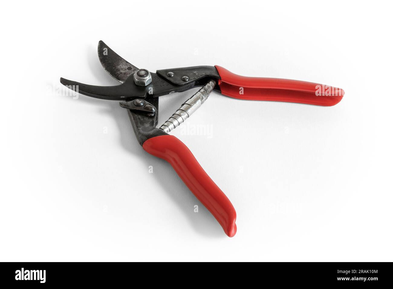 A pair of red-handled garden secateurs in open position, isolated on a white background, UK Stock Photo