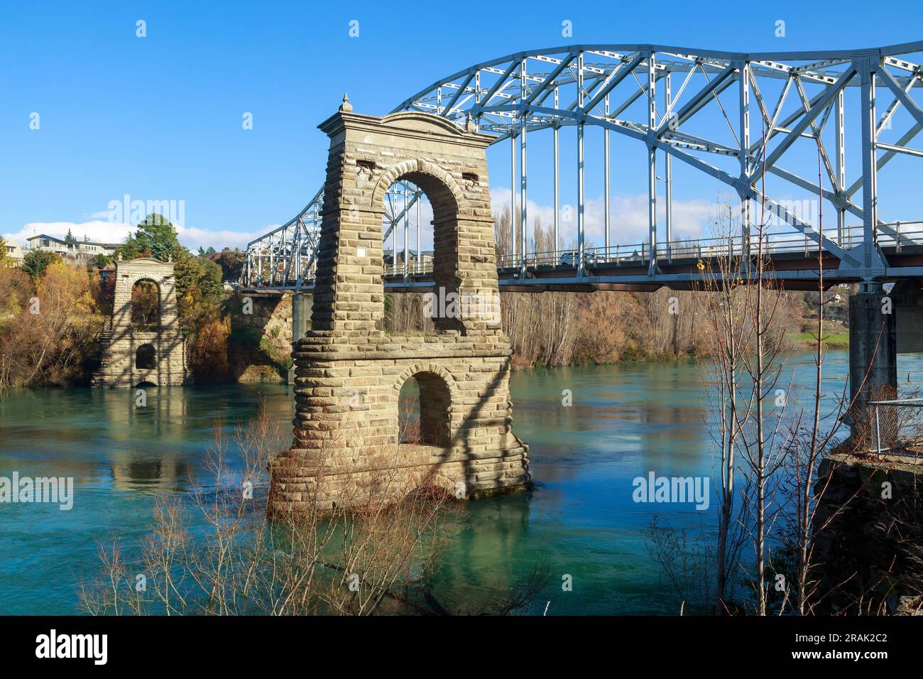 Alexandra, New Zealand. The towers of the old (1882) bridge beside the modern bridge over the Clutha River Stock Photo