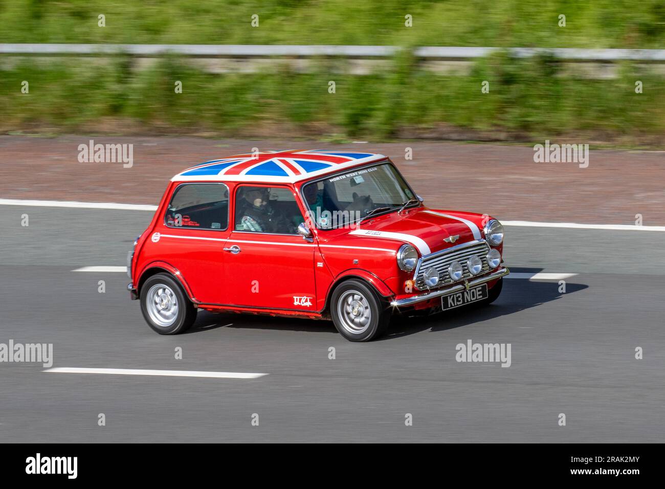 1993 90s nineties Rover Mini Cooper 1.3I Red Car Saloon Petrol 1275 cc travelling at speed on the M6 motorway in Greater Manchester, UK Stock Photo