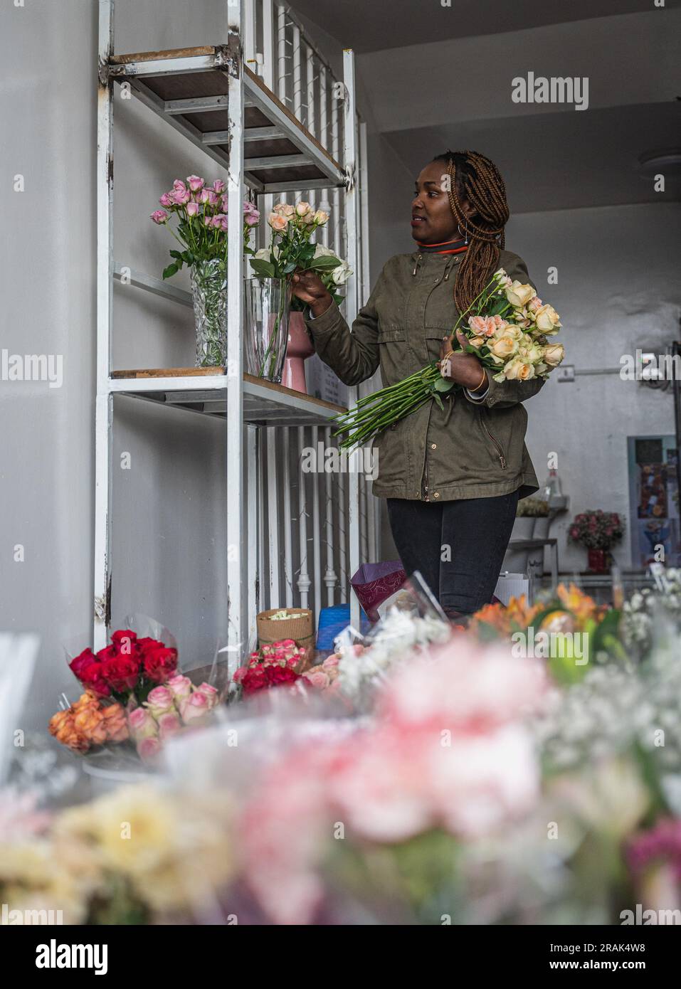 Nairobi. 4th July, 2023. A vendor arranges flowers at a flower shop in