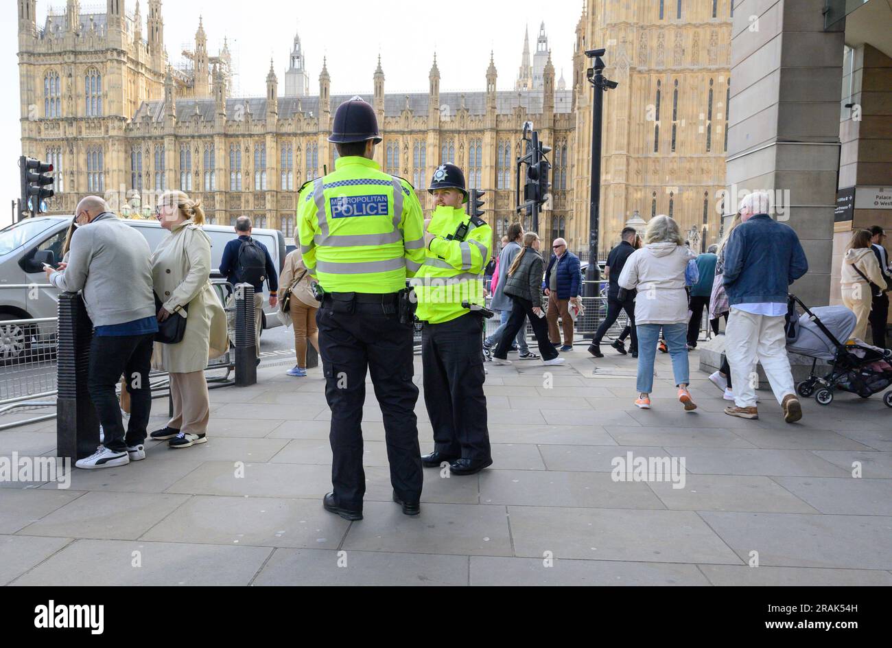 London, UK. Metropolitan Police officers on duty in Westminster by the Houses of Parliament Stock Photo