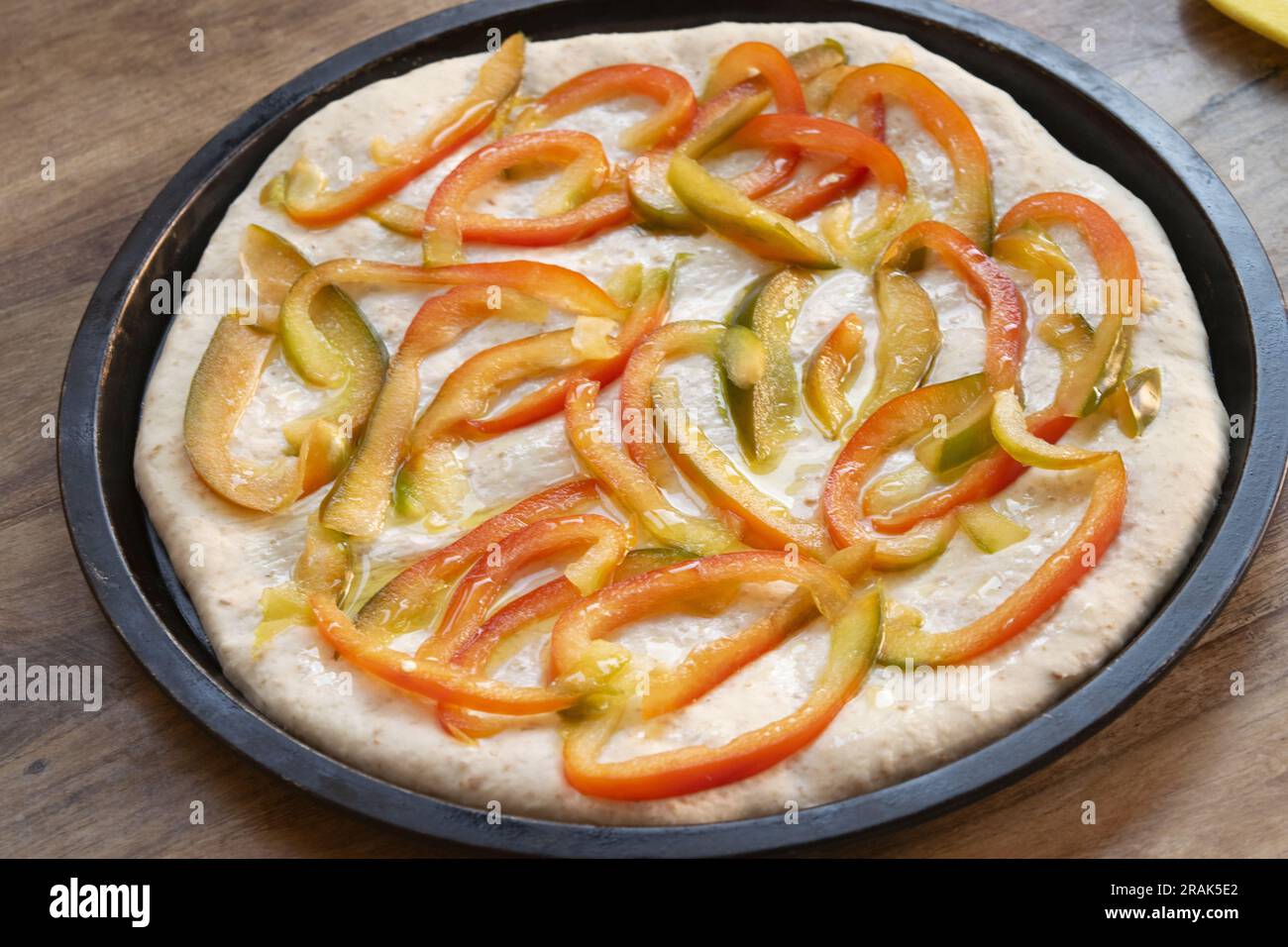 pizza with peppers yet to be baked Stock Photo