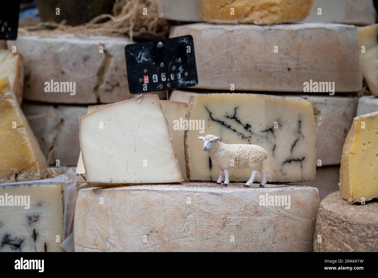 A cheese stall on a market in Chinon Loire Valley, France with cheese piled up for sale. Stock Photo