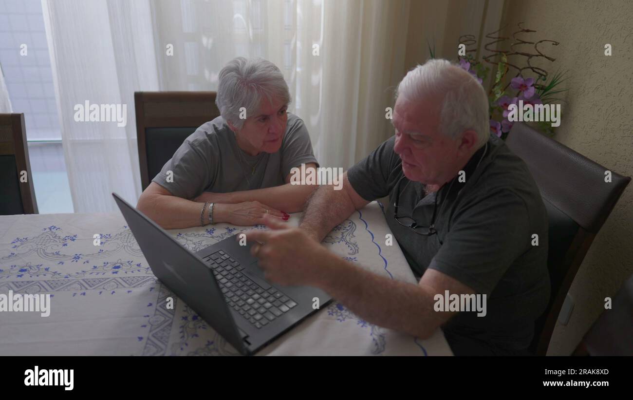 Elderly couple using laptop at home, old age and modern technology ...