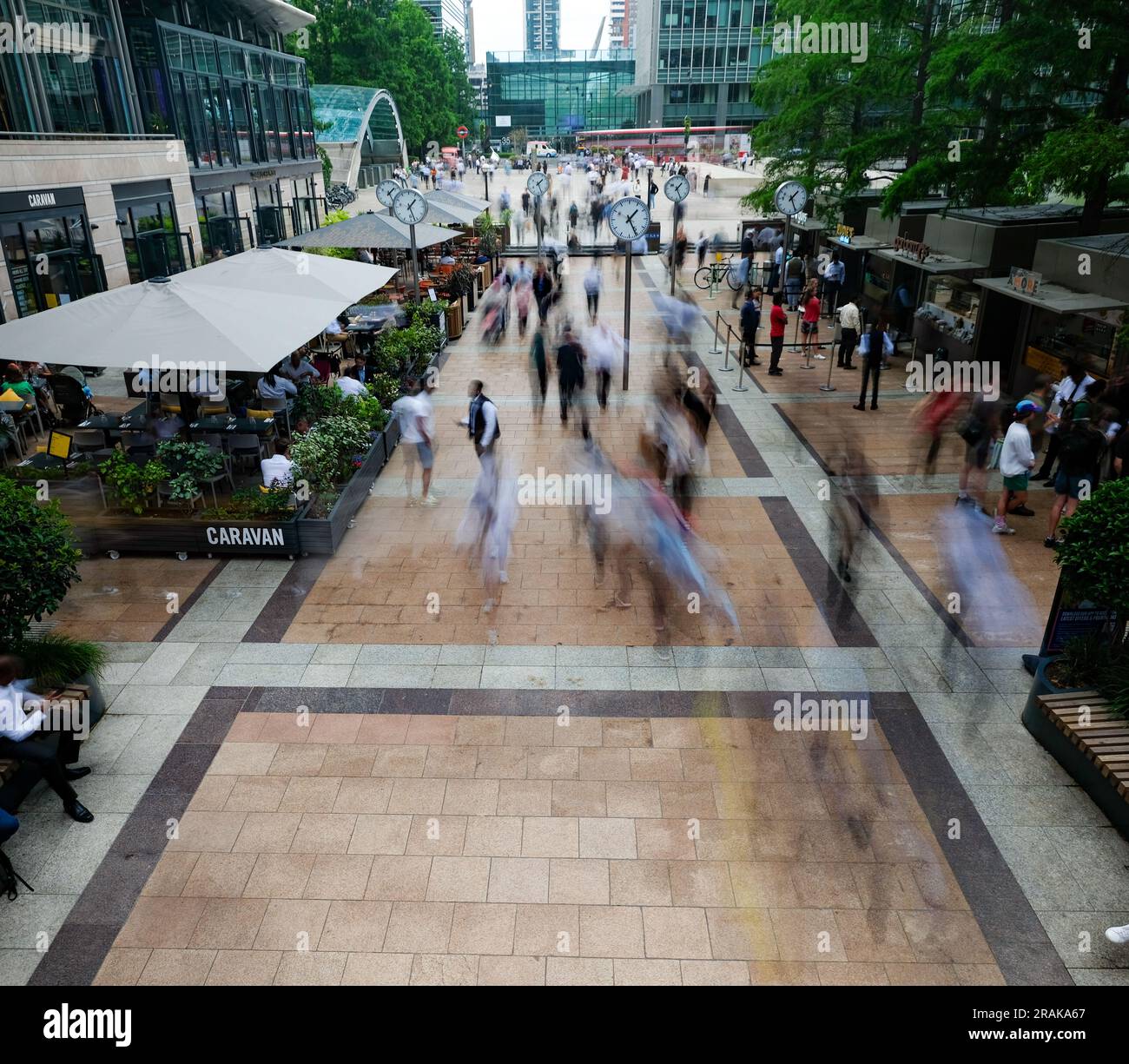 London- June 2023: Motion blurred business people in Reuters Plaza, London's Canary Wharf financial district. Stock Photo