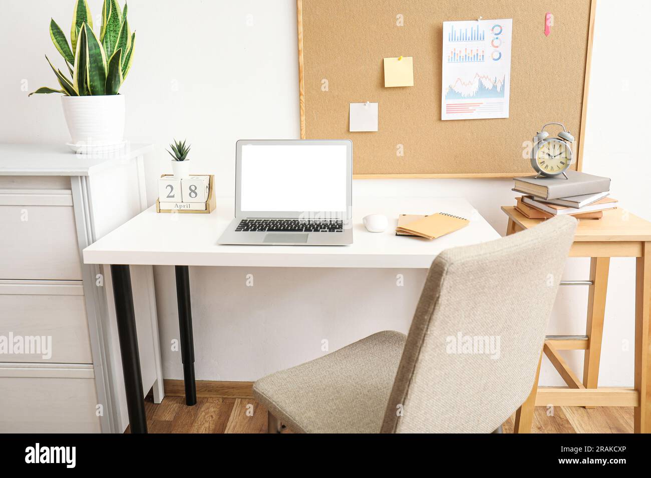Modern laptop with blank screen on table in office Stock Photo - Alamy