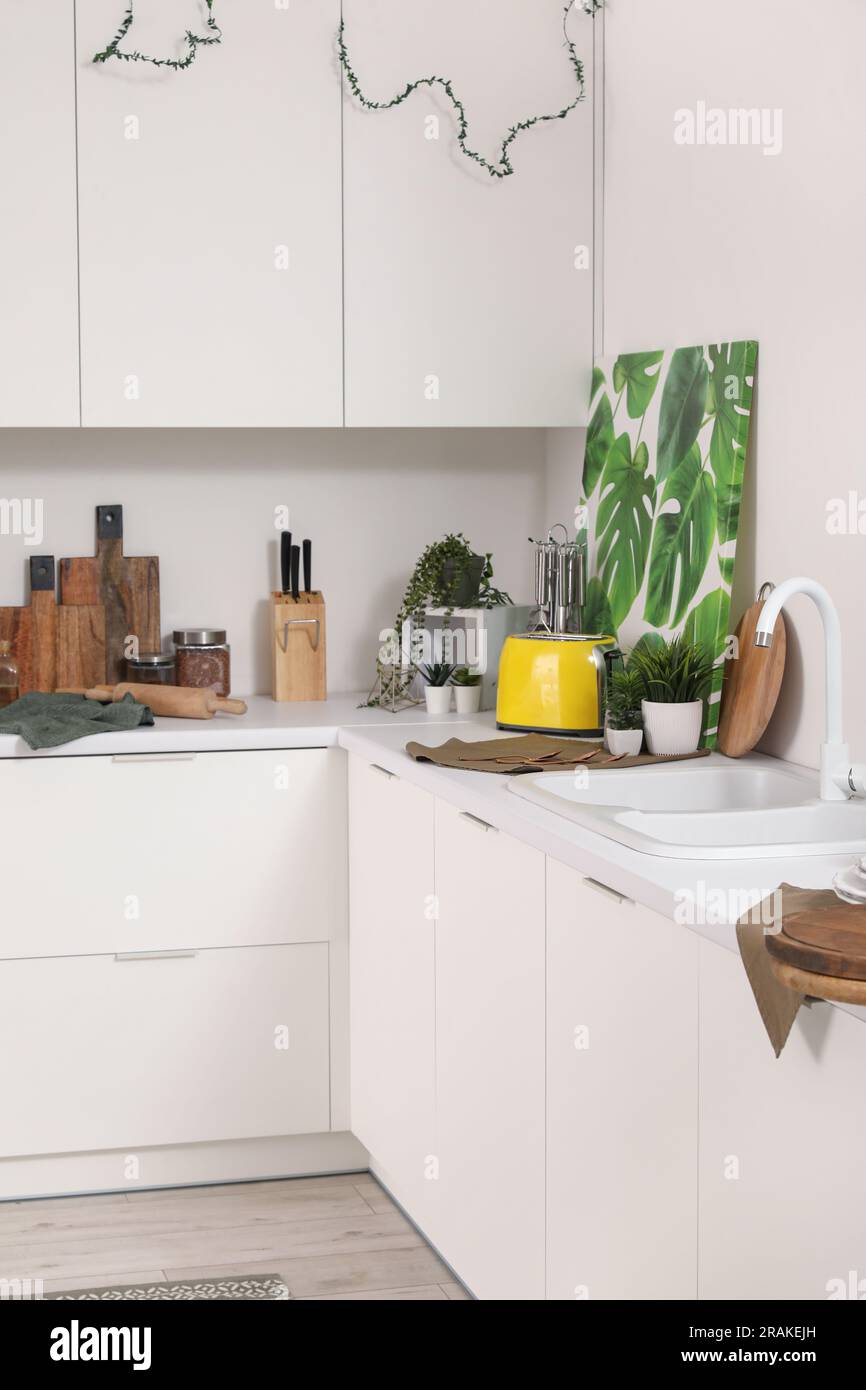Interior of modern kitchen with white counters and utensils Stock Photo ...