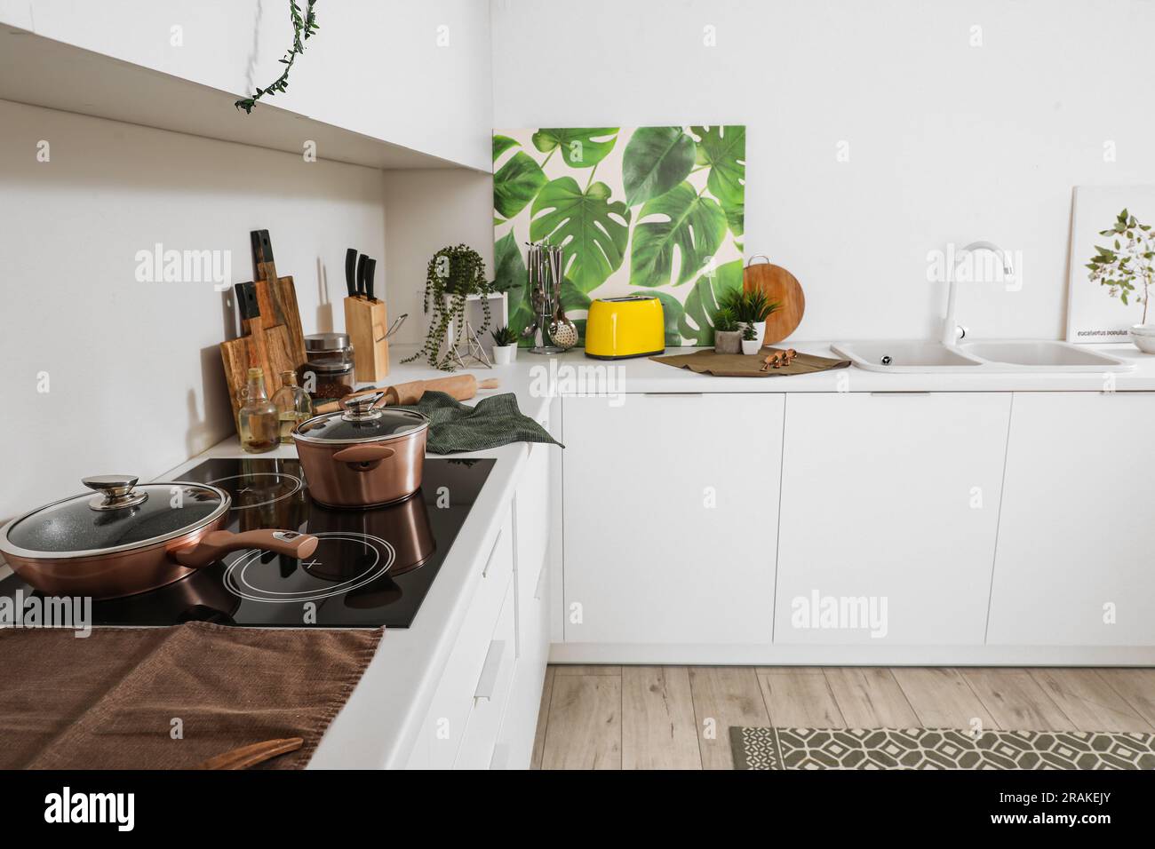 Interior of modern kitchen with white counters and utensils Stock Photo ...