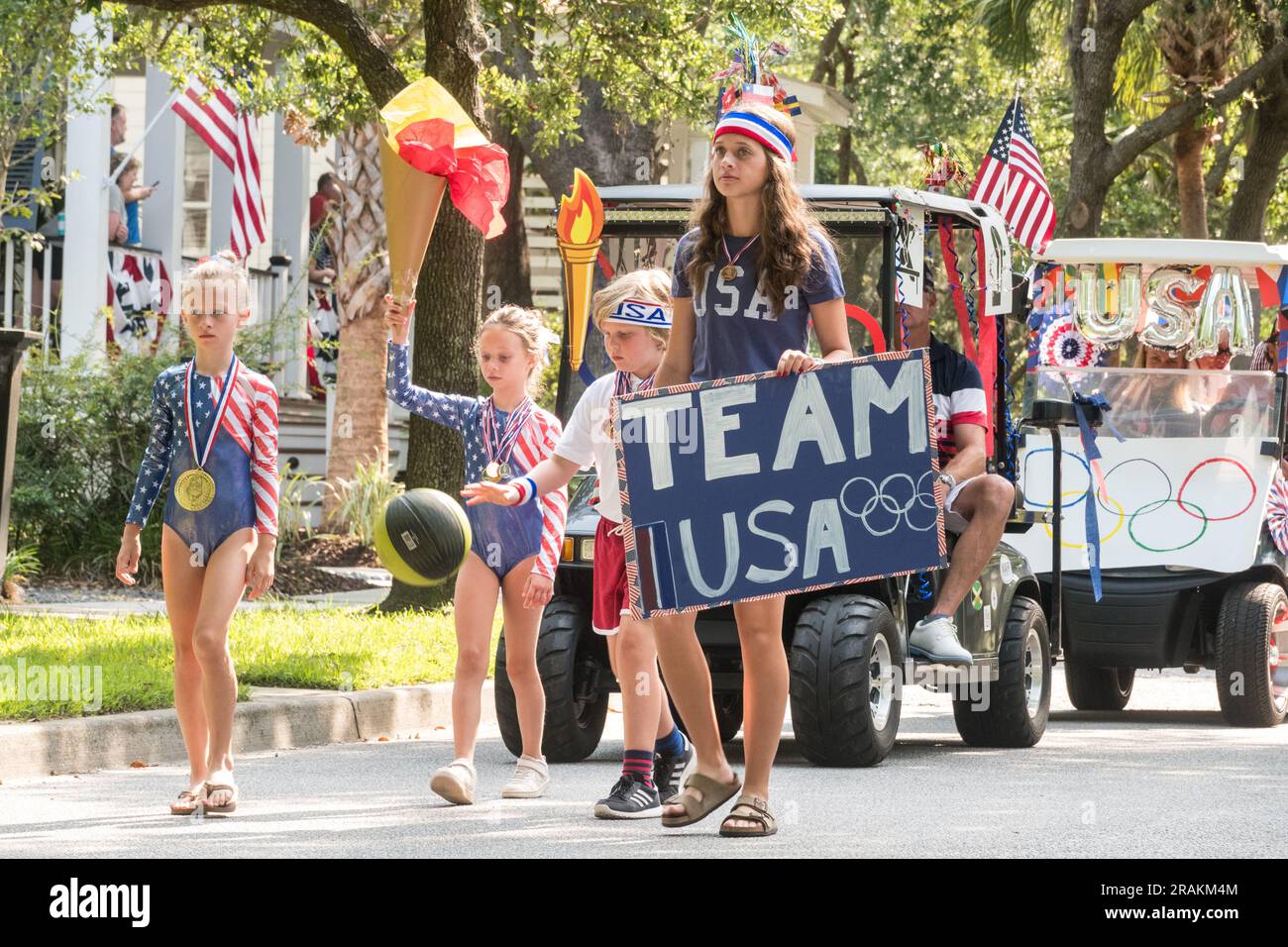 Children dressed in patriotic colors honor the USA Olympic team during the annual Bicycle and Golf cart parade celebrating Independence Day at the I’on Community, July 4, 2021 in Mt Pleasant, South Carolina. Stock Photo