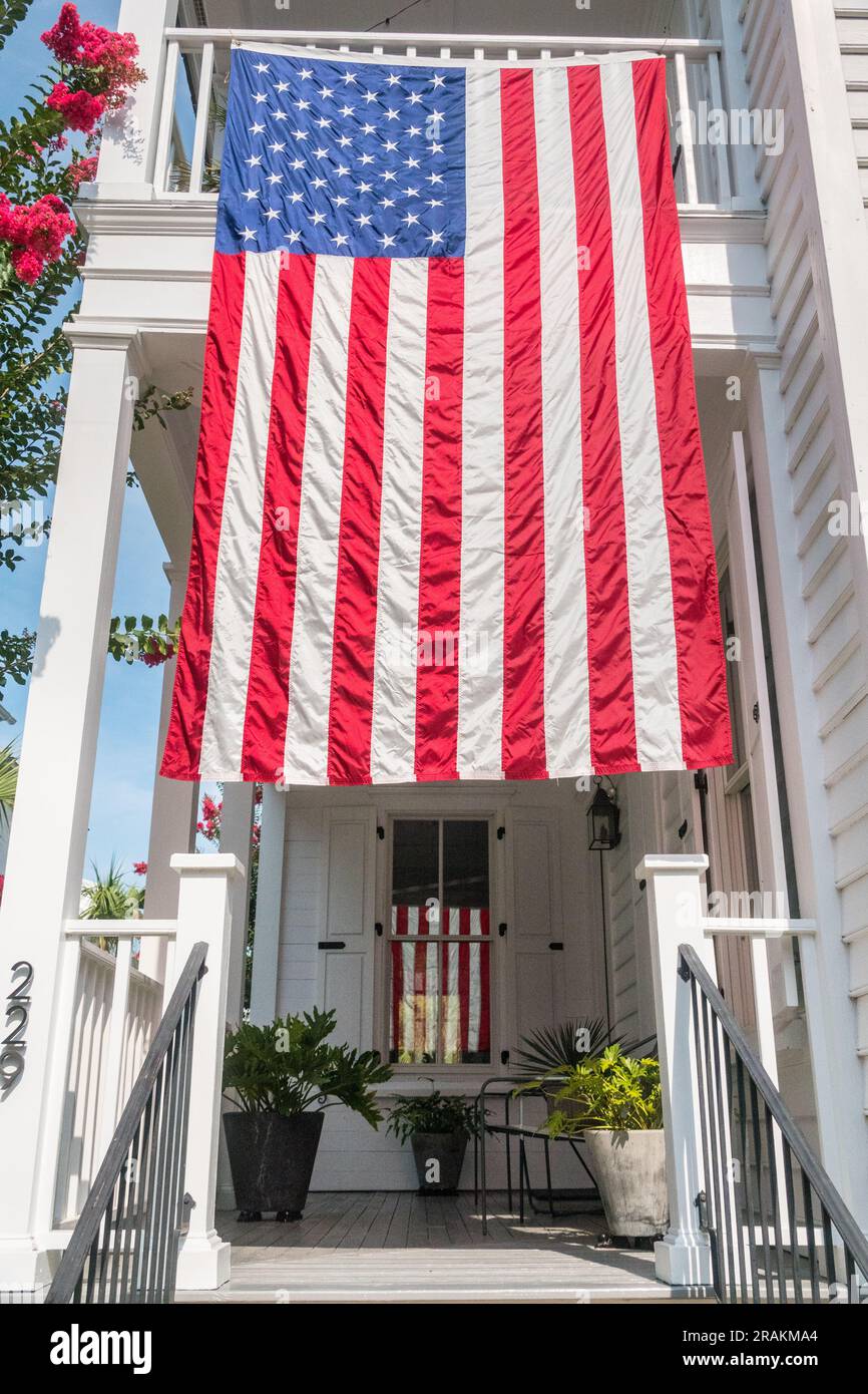 A Charleston single low country style home decorated with the American flag in honor of Independence Day at the I’on Community, July 4, 2021 in Mt Pleasant, South Carolina. Stock Photo