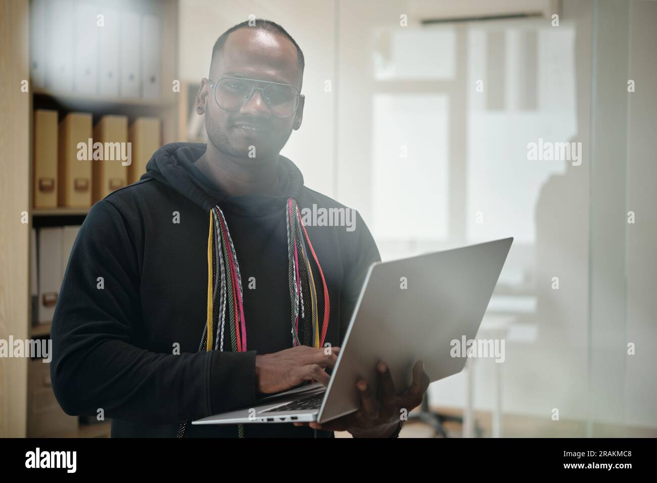 Portrait of senior developer with laptop committing programming code Stock Photo