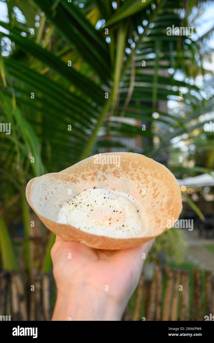 Sri lankan street food egg hopper in woman's hand Stock Photo Alamy