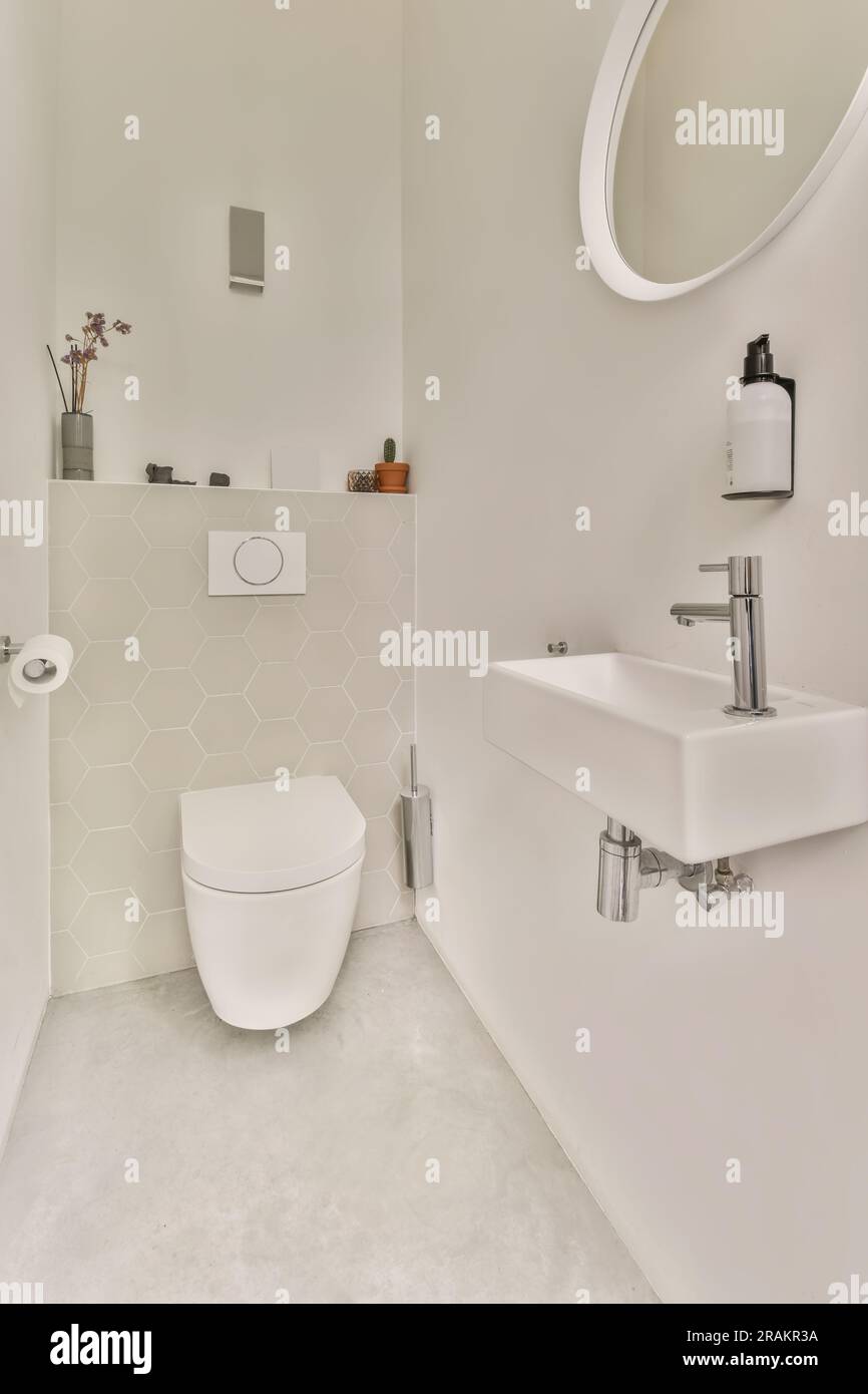 a modern bathroom with white walls and hexagon tiles on the floor