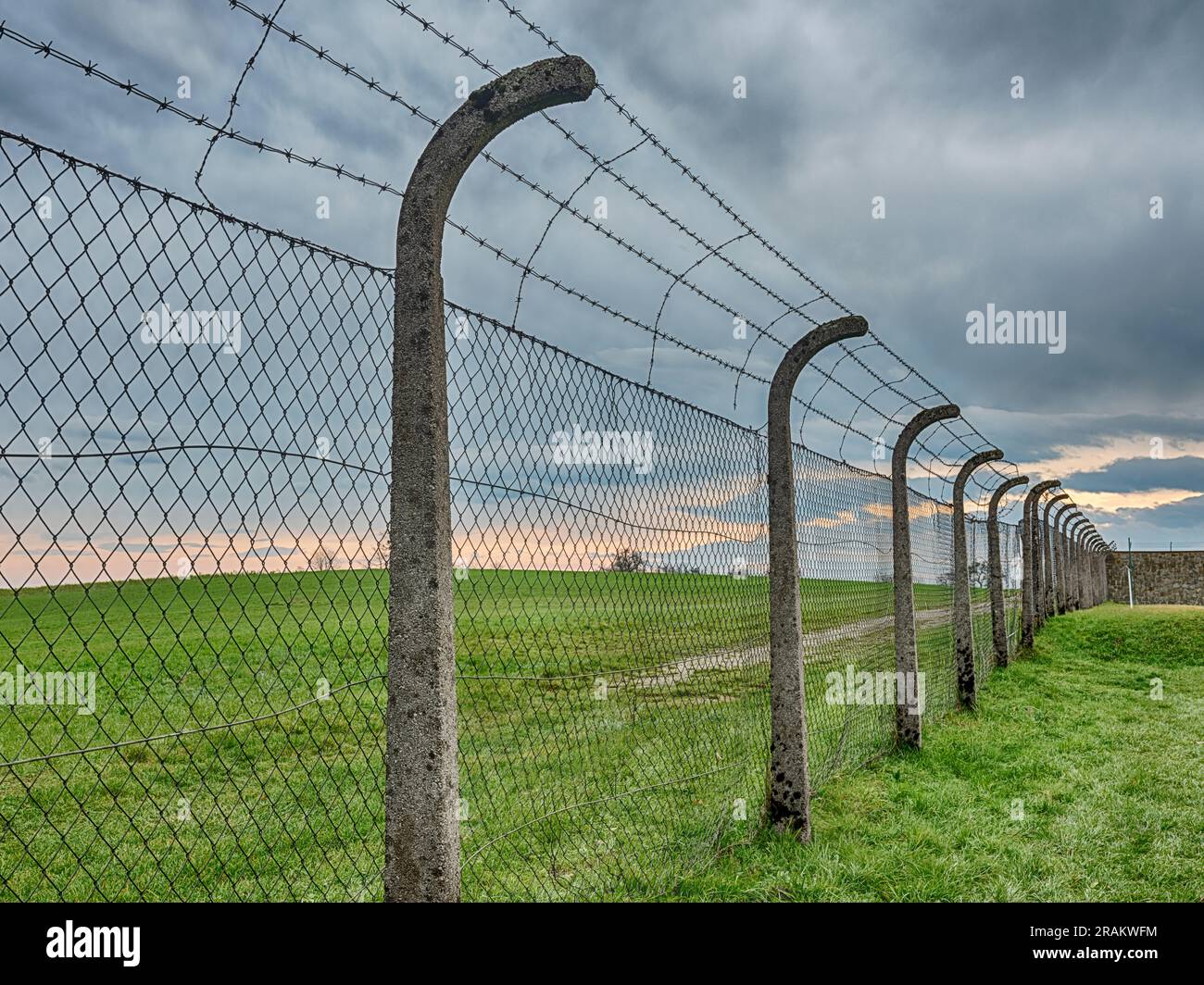 MAUTHAUSEN, AUSTRIA - DECEMBER 4, 2022: An electrified fence separated the barracks area from the countryside at the Mauthausen concentration camp in Stock Photo