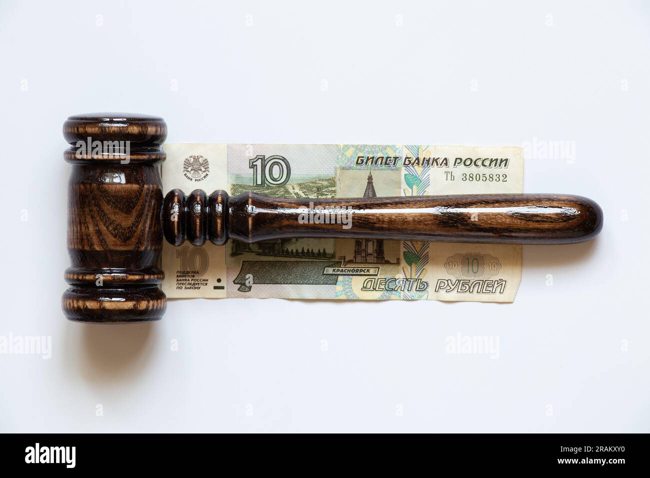 The gavel of the judge lies on 10 rubles on a white background, law and