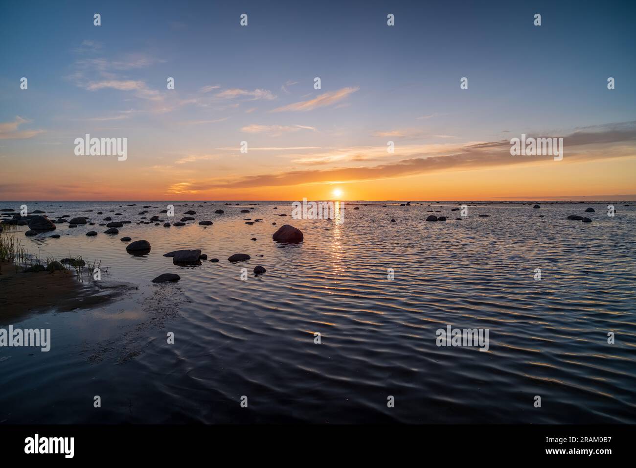 Bright sunset with large yellow sun under the sea surface Stock Photo