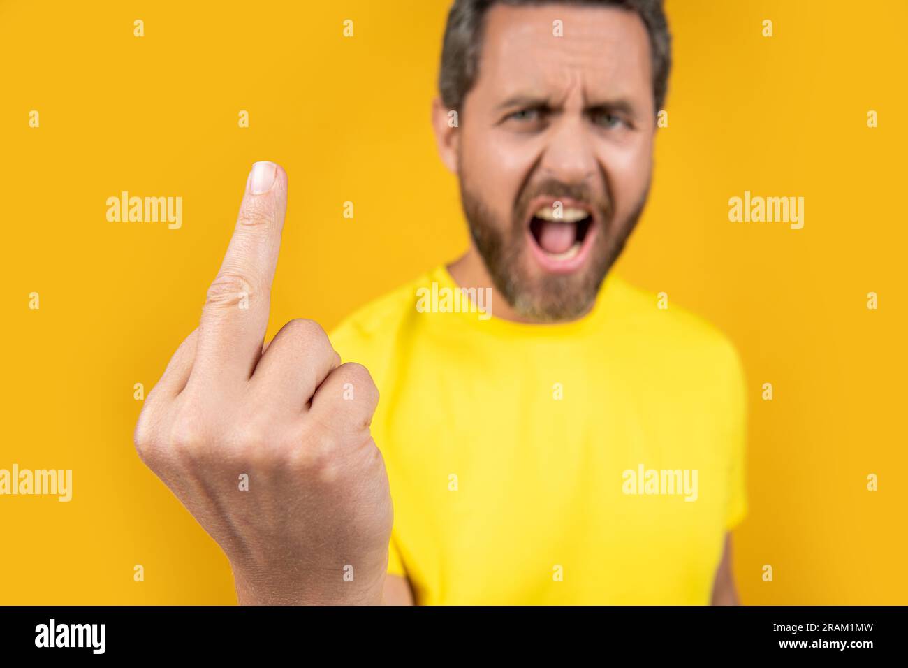 rude middle finger gesture isolated on yellow. rude middle finger ...