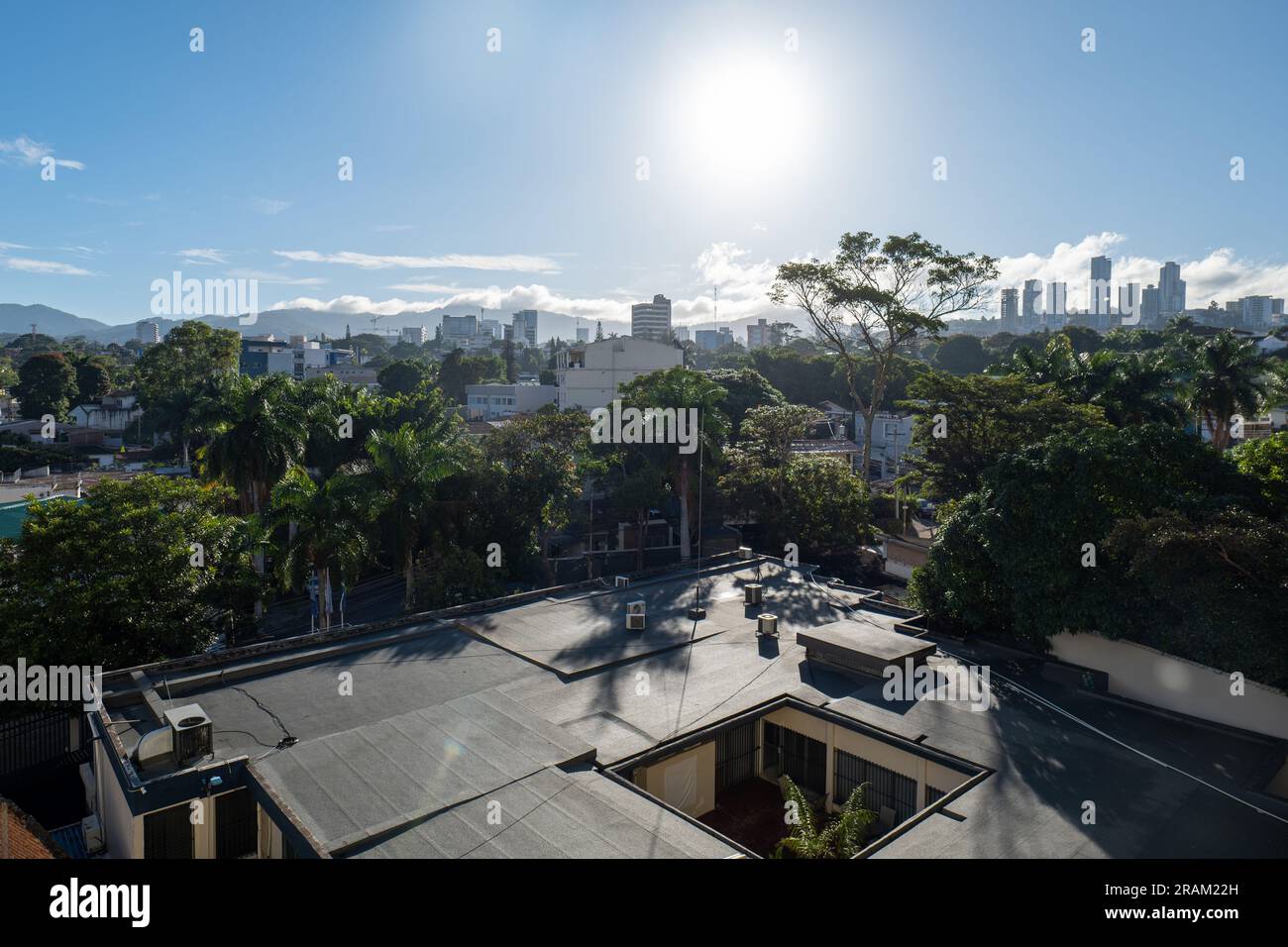 Tegucigalpa, Francisco Morazan, Honduras - December 7, 2022: Panoramic View of the City with Houses, Buildings, and Trees Surrounded by Green Mountain Stock Photo